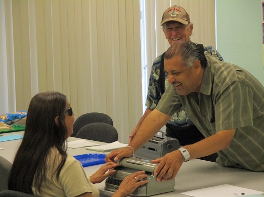 Ciro and Ramiro helping Mary in the Braille club